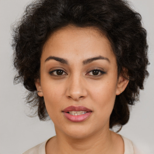 Joyful latino young-adult female with medium  brown hair and brown eyes