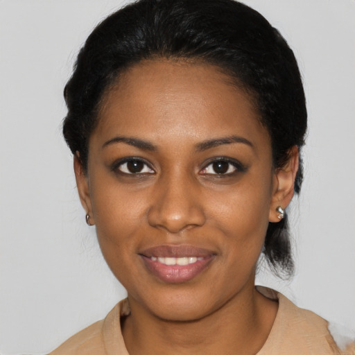Joyful black young-adult female with short  black hair and brown eyes