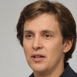 Joyful white adult male with medium  brown hair and brown eyes