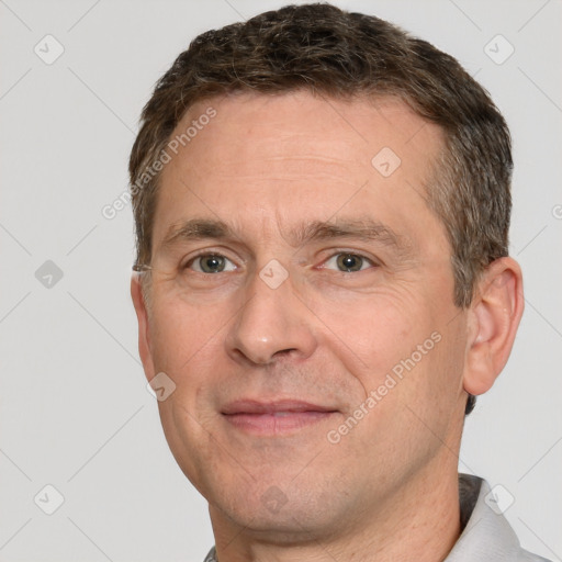 Joyful white adult male with short  brown hair and brown eyes