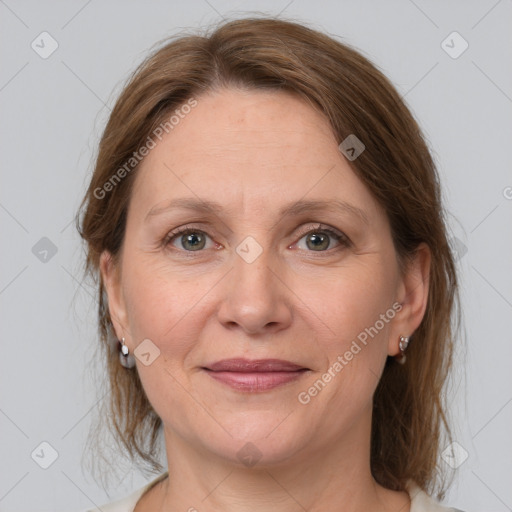 Joyful white adult female with medium  brown hair and grey eyes