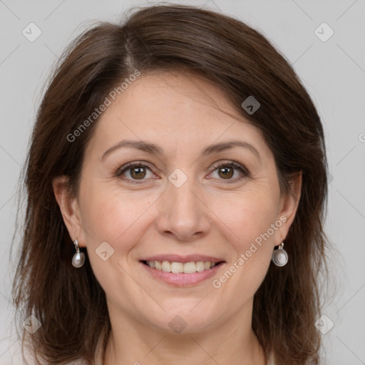 Joyful white adult female with medium  brown hair and grey eyes