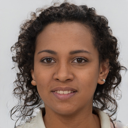 Joyful black young-adult female with long  brown hair and brown eyes