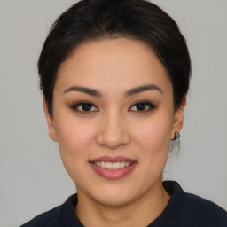 Joyful asian young-adult female with medium  black hair and brown eyes