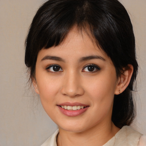 Joyful asian young-adult female with medium  brown hair and brown eyes