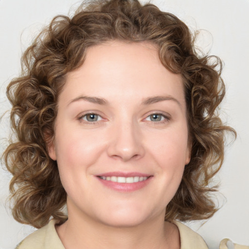 Joyful white young-adult female with medium  brown hair and blue eyes