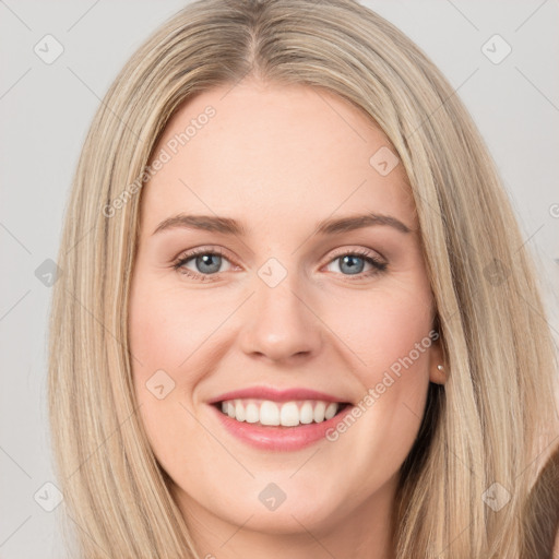 Joyful white young-adult female with long  brown hair and green eyes