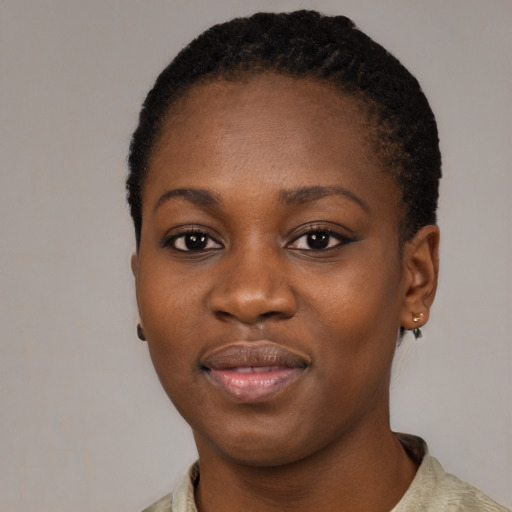 Joyful black young-adult female with short  black hair and brown eyes