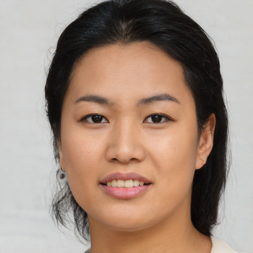 Joyful asian young-adult female with medium  black hair and brown eyes