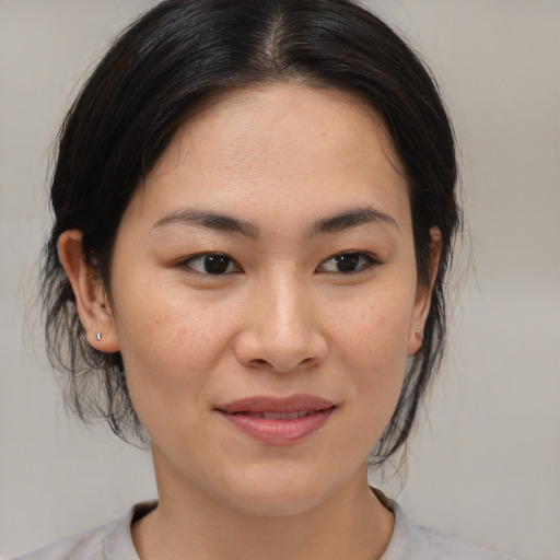 Joyful asian young-adult female with medium  brown hair and brown eyes