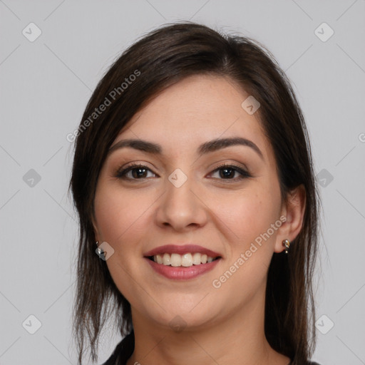 Joyful white young-adult female with long  brown hair and brown eyes