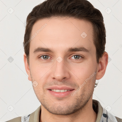 Joyful white young-adult male with short  brown hair and grey eyes