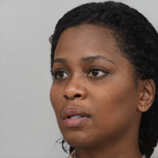Neutral black young-adult female with short  black hair and brown eyes