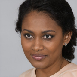 Joyful black young-adult female with medium  brown hair and brown eyes