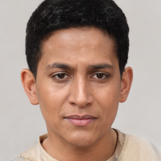 Joyful latino young-adult male with short  brown hair and brown eyes