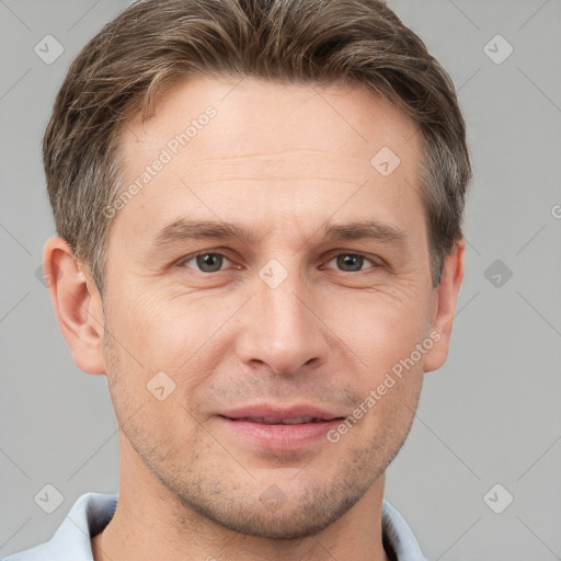 Joyful white adult male with short  brown hair and grey eyes