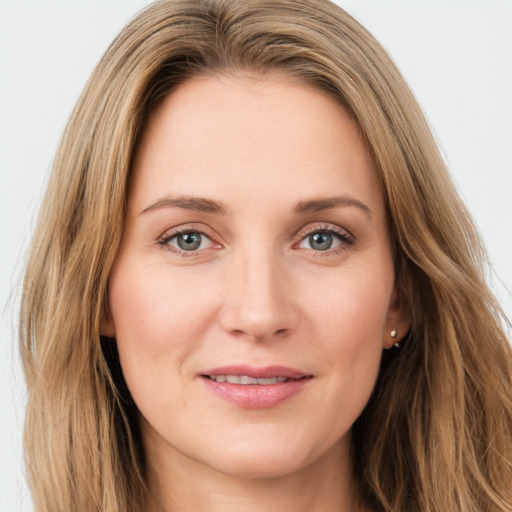 Joyful white young-adult female with long  brown hair and green eyes