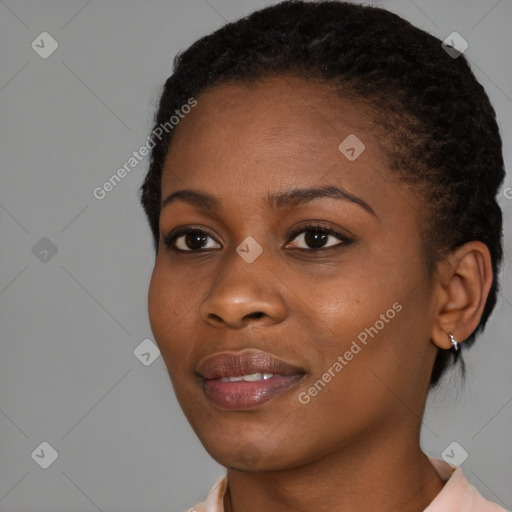 Joyful black young-adult female with short  black hair and brown eyes