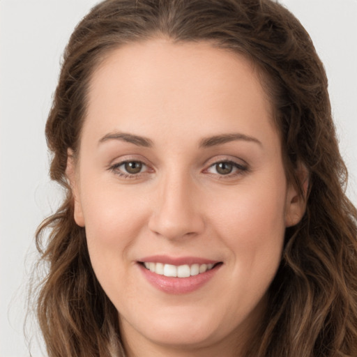 Joyful white young-adult female with long  brown hair and brown eyes