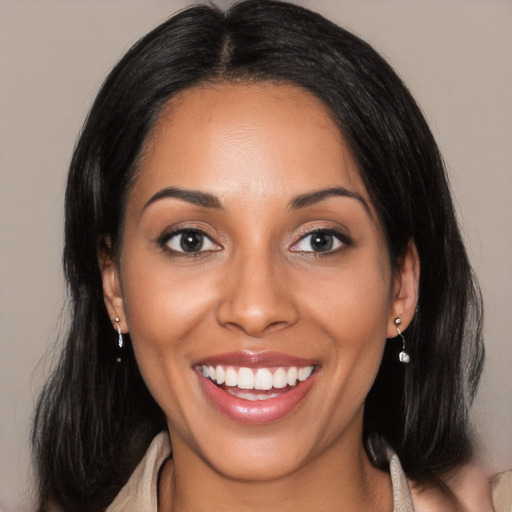 Joyful latino young-adult female with long  black hair and brown eyes