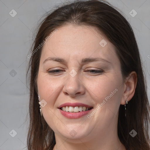 Joyful white adult female with long  brown hair and grey eyes