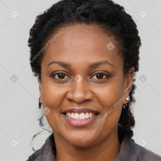 Joyful black adult female with short  brown hair and brown eyes