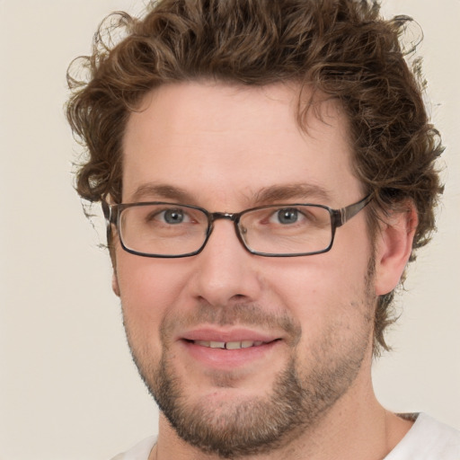 Joyful white young-adult male with short  brown hair and green eyes