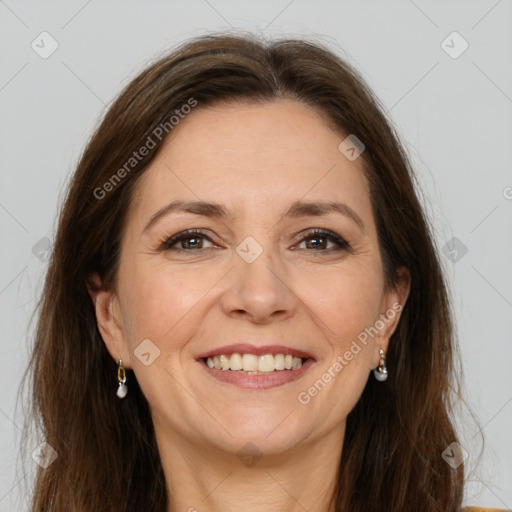 Joyful white adult female with long  brown hair and brown eyes