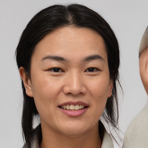 Joyful white young-adult female with medium  black hair and brown eyes