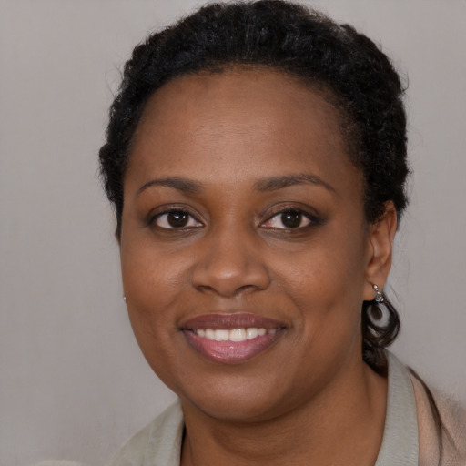 Joyful black young-adult female with short  brown hair and brown eyes