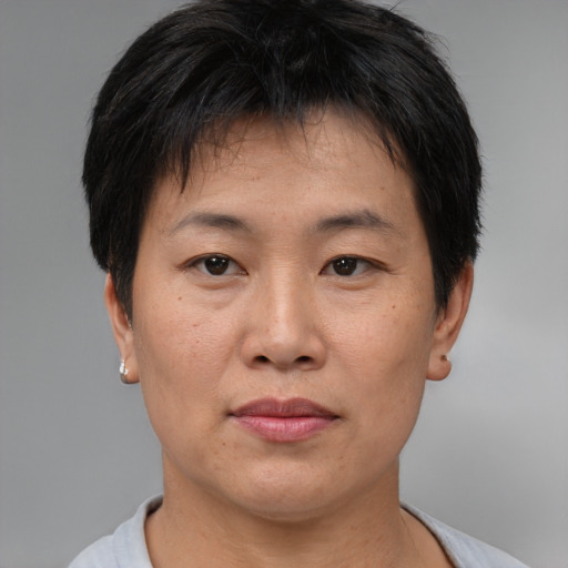 Joyful asian adult male with short  brown hair and brown eyes