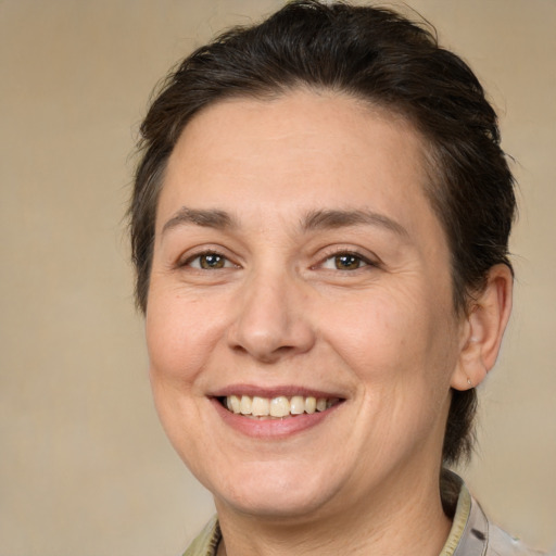Joyful white adult female with medium  brown hair and brown eyes