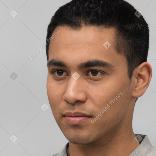 Joyful latino young-adult male with short  black hair and brown eyes