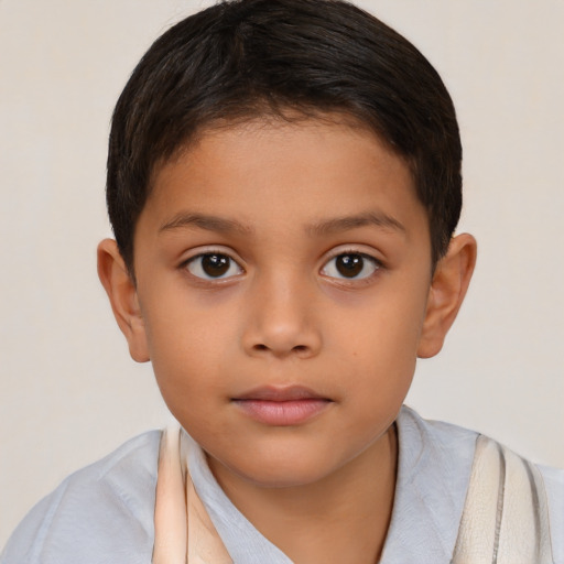 Joyful latino child female with short  brown hair and brown eyes