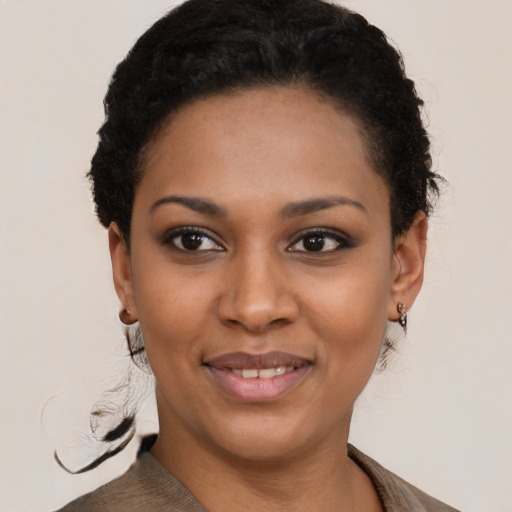 Joyful black young-adult female with short  brown hair and brown eyes