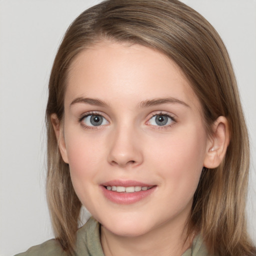 Joyful white young-adult female with long  brown hair and grey eyes