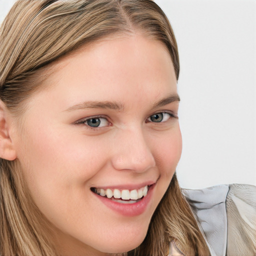 Joyful white child female with long  brown hair and blue eyes