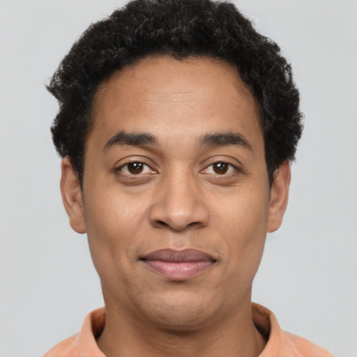 Joyful latino adult male with short  brown hair and brown eyes