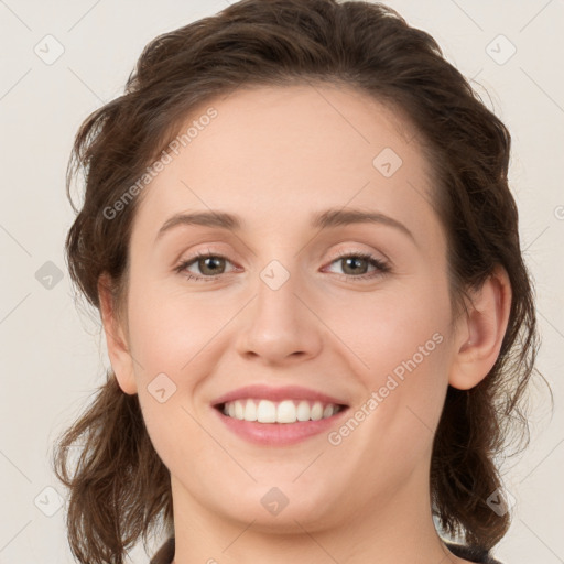 Joyful white young-adult female with long  brown hair and green eyes