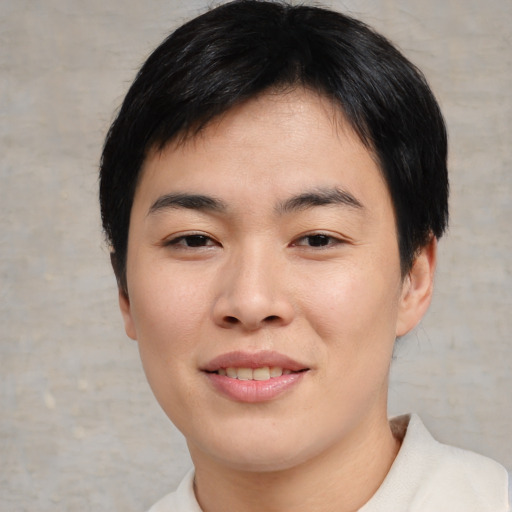 Joyful asian young-adult female with short  black hair and brown eyes