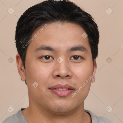 Joyful asian young-adult male with short  brown hair and brown eyes