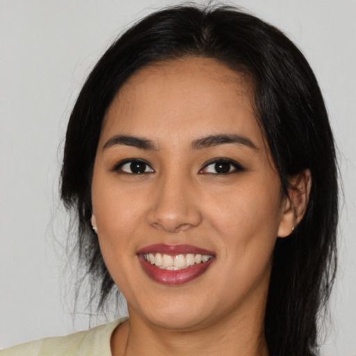 Joyful latino young-adult female with medium  black hair and brown eyes