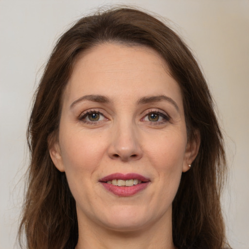 Joyful white adult female with medium  brown hair and brown eyes