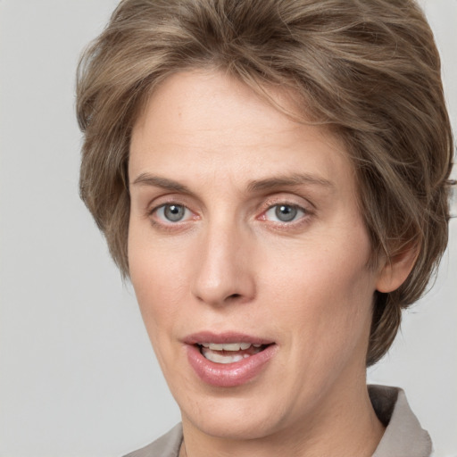 Joyful white adult female with medium  brown hair and grey eyes