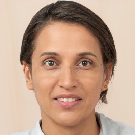 Joyful white adult female with short  brown hair and brown eyes