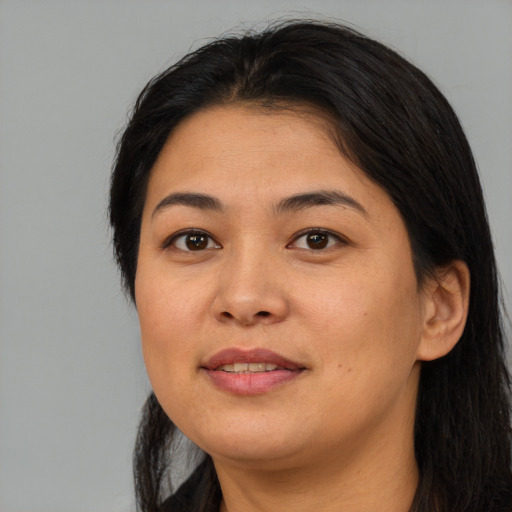 Joyful asian young-adult female with long  brown hair and brown eyes