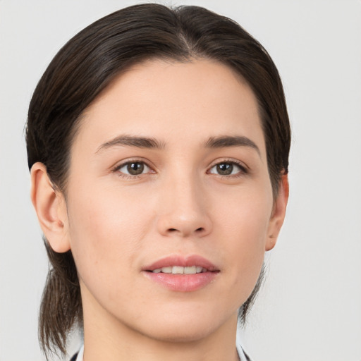 Joyful white young-adult female with medium  brown hair and brown eyes