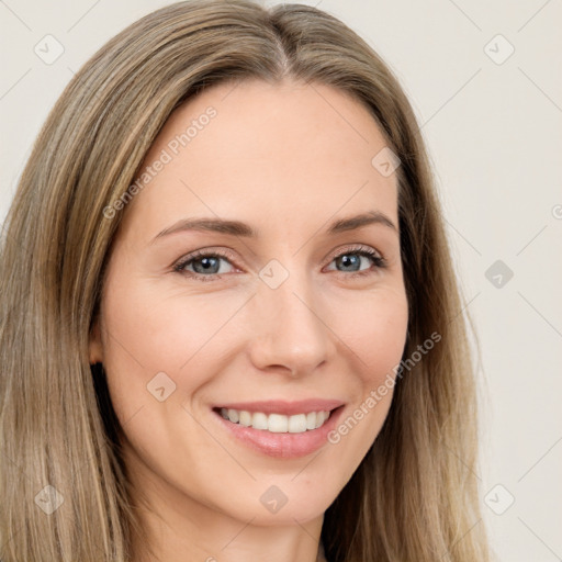 Joyful white young-adult female with long  brown hair and brown eyes