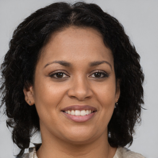Joyful latino young-adult female with medium  brown hair and brown eyes