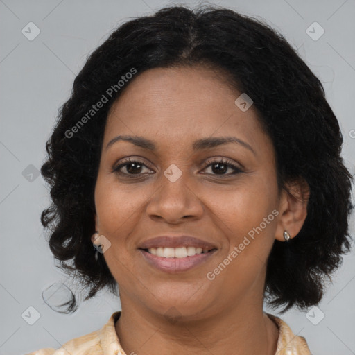 Joyful black adult female with medium  brown hair and brown eyes